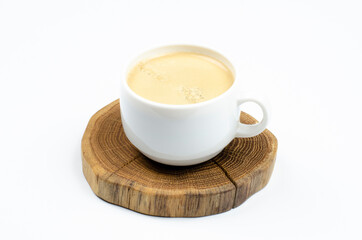 A cup of coffee. Frothy coffee. White cup. On white background.