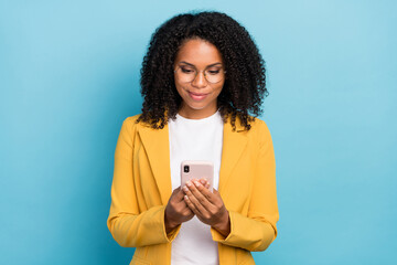 Photo of young african woman happy positive smile look read browse internet smartphone isolated...