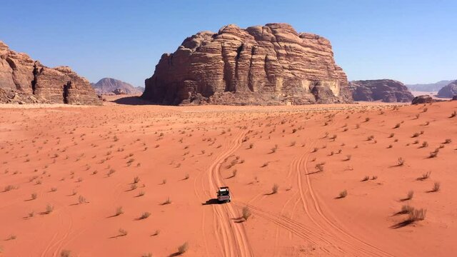 Aerial Shot From Above With Group Of People Driving In Off Road Vehicle In The Middle Of The Wadi Rum Desert, Jordan