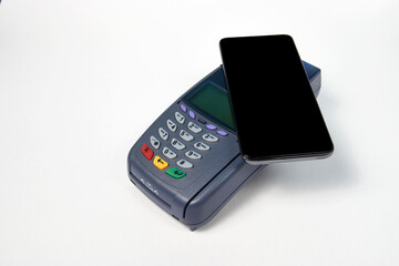 Payment terminal and phone on white background