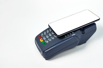 Payment terminal and phone on white background