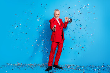 Photo of man hold mic shiny ball glitter fall event invitation concept wear red suit shoes isolated...