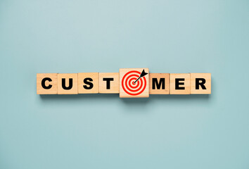 Top view or flat lay of customer wording on wooden cube block with red target board with arrow...