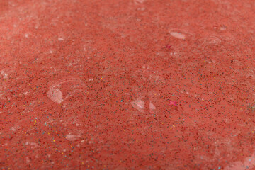 Liquid art gel background. Abstract textured coral background transparent slime with bubbles inside. Macro of kids toy slime.