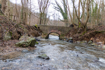 Flooding river creek destroyed a bridge after heavy rain flood water shows the forces of nature and...