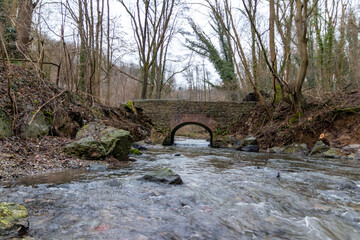 Flooding river creek destroyed a bridge after heavy rain flood water shows the forces of nature and...