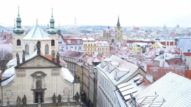 Panorama of Prague Klementinum and roofs covered with snow in winter, Czech Republic