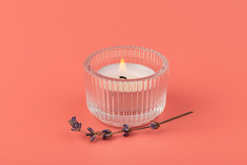 Candle in glass on pink background with lavender, product mock-up. Floral design element. Aromatherapy and herbal medicine concept