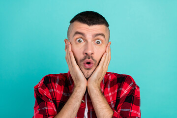 Photo of amazed shocked man hold hands face sale news reaction astonished isolated on teal color background