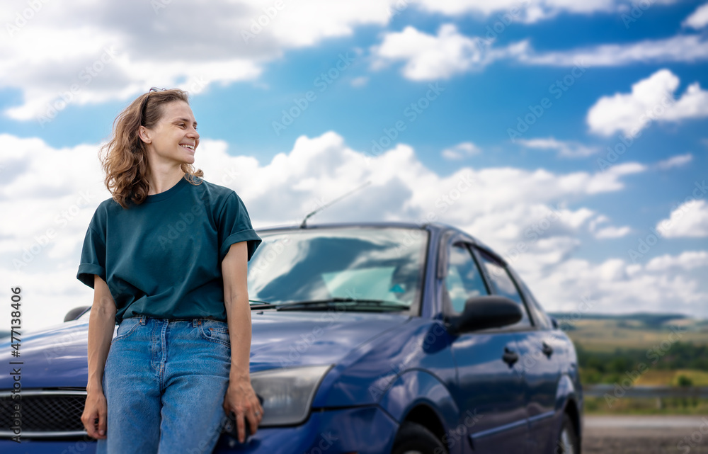 Wall mural summer travel by car. portrait of beautiful young female woman on the background of transport and su