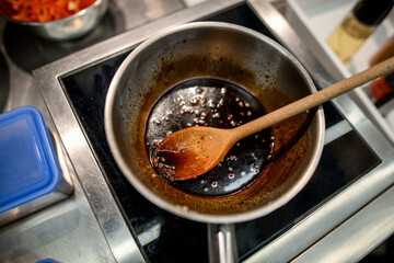 view of a steel bowl in which the sauce with spices is prepared