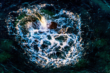 The waves of the sea in Benidorm, Spain, breaking against the rocks form a heart