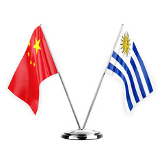 Two table flags isolated on white background 3d illustration, china and uruguay