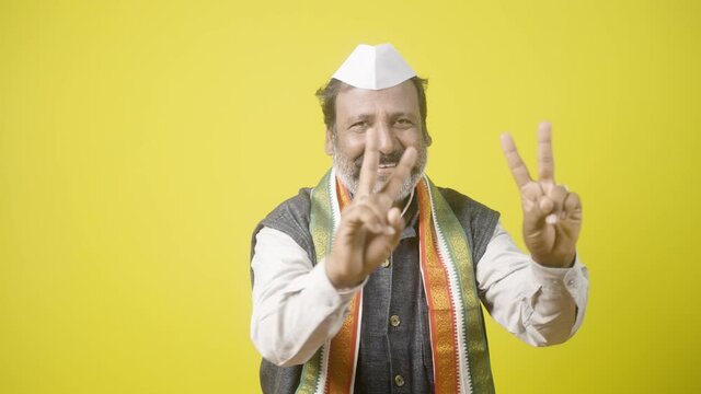 happy smiling Politician showing victory or v sign gesture to audience - concept of Poll victory, positive or confidence about election results and win or successful celebration.