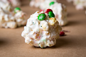 Red and green popcorn balls with chocolate and marshmallows