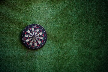 Darts hitting the bullseye of a dart board background