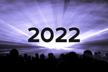 Happy new year 2022 purple laser show party people crowd. Luxury entertainment with audience...