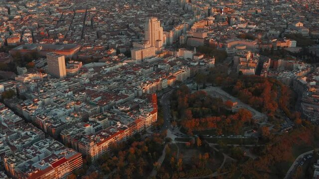 Aerial panoramic footage of city at sunset. Buildings illuminated by last sun rays of day.