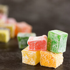 Turkish delight on a gray background. selective focus