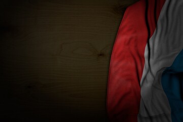 cute dark picture of Luxembourg flag with large folds on dark wood with empty place for your text - any celebration flag 3d illustration..