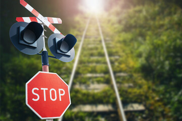 Stop sign background. Long railway landscape. Road sign suggesting caution. Watch out for a train. Rail crossing danger background.