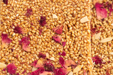 Detailed Closeup Of Sesame Seed Rose Peanut Brittle Bars Known As Tilgul Gulab Gud Patti Chikki Mithai Or Gur Papadi Made Of Til, Jaggery, Flower Petals. Winter Sweet For Makar Sankranti Or Lohri