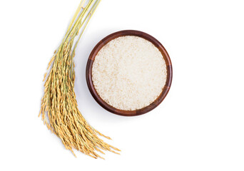 Jasmine or white rice in a wooden bowl with ears of rice isolated on a white background, top view