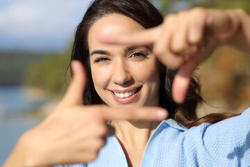 Front view of woman framing with hands looking at you