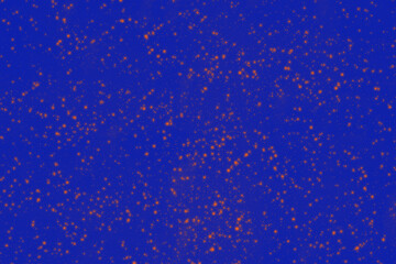 Niebieskie tło z pomarańczowymi, nakrapianymi cętkami.