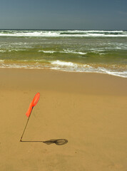 A metaphor illustrated with a child’s fishing net cast in contrast against the endless Indian Ocean
