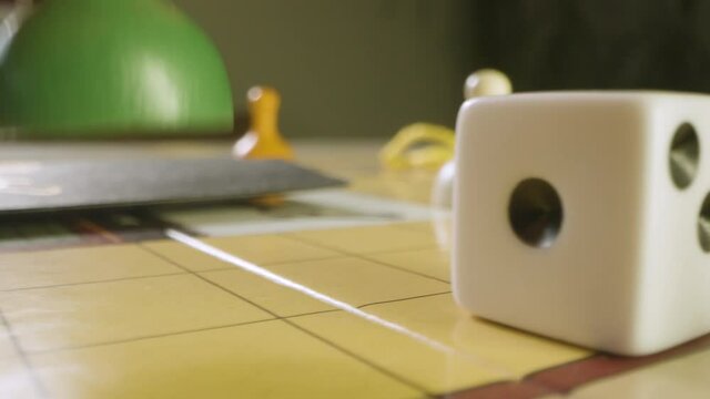 Close Up Pan Rolling Die and Moving Pawn in Cluedo Game. High quality video footage