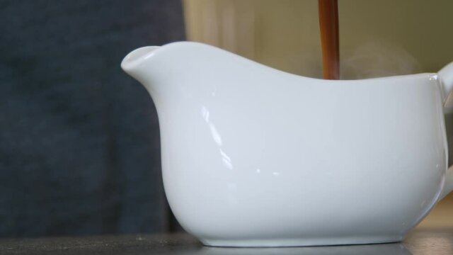 Close Up Pouring Gravy into Gravy Boat. High quality video footage