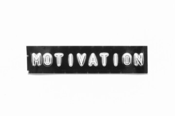 Embossed letter with word motivation in black banner on white paper background