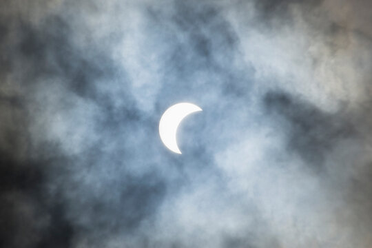 Solar eclipse and clouds on sky