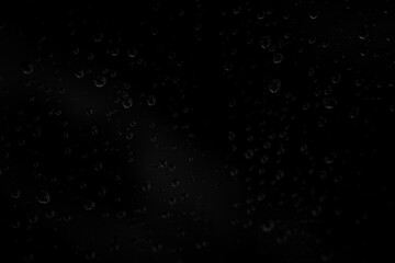 water drops on window over dark background