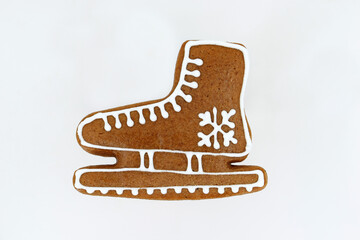 Gingerbread in a shape of ice skate decorated with white icing 