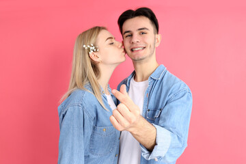 Cute couple with finger heart on pink background