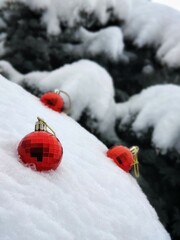 Red Christmas balls in snow with selective focus
