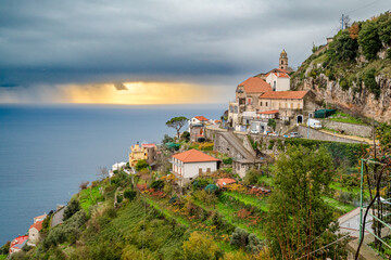 Amalfi coast near Furore, San Michele, Amalfi Coast, Italy, with Tyrrhenian Sea and sunset behind gray clouds - obrazy, fototapety, plakaty