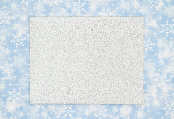 Blank silver sparkle greeting card on blue and white snowflakes