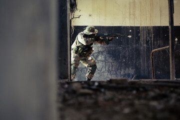 Airsoft solder on battlefield. Airsoft soldier with a rifle.