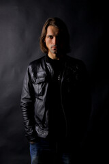 Portrait of a man with shadow on his face on a dark background