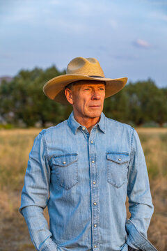 Senior man in denim shirt and cowboy hat