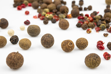 Scattered pepper close-up isolated on a white background.