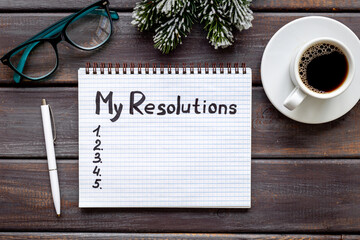 New Year resolution hand writing list - text on notepad, top view