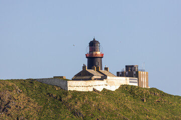 Fototapeta na wymiar Ballycotton Lighthouse and Cliff rocks, Ireland