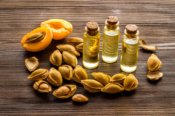 Bottles of apricot kernel oil with ripe apricot fruits
