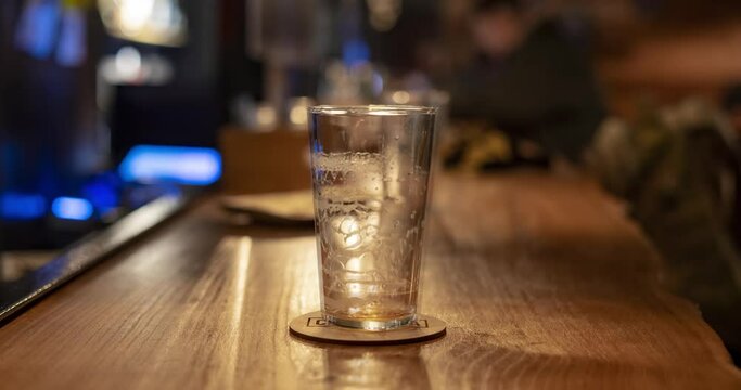drinking three glasses of beer in a row at the bar counter, a time lapse shot