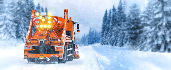 Snow plow drive tackles snowy road on bad weather and snow fall. Snow plow on highway salting road....
