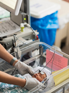 Infant baby girl (0-1 months) having hearing test done